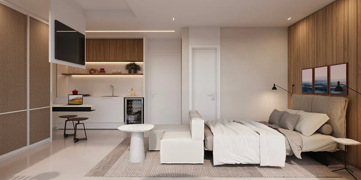Studio decorado do Estação Botafogo Residencial com cama, sofá e copa integrada